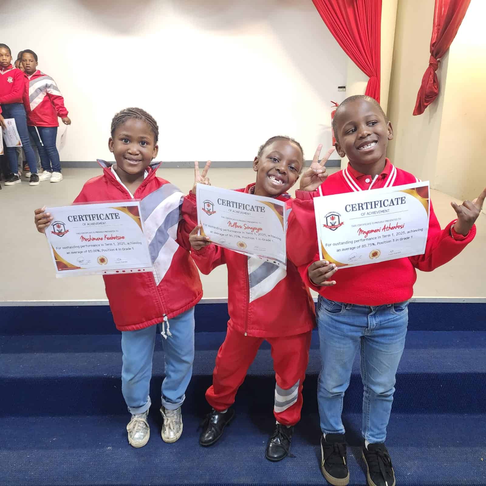 Happy students holding certificates of achievement, celebrating academic success at Tulip Combined School.